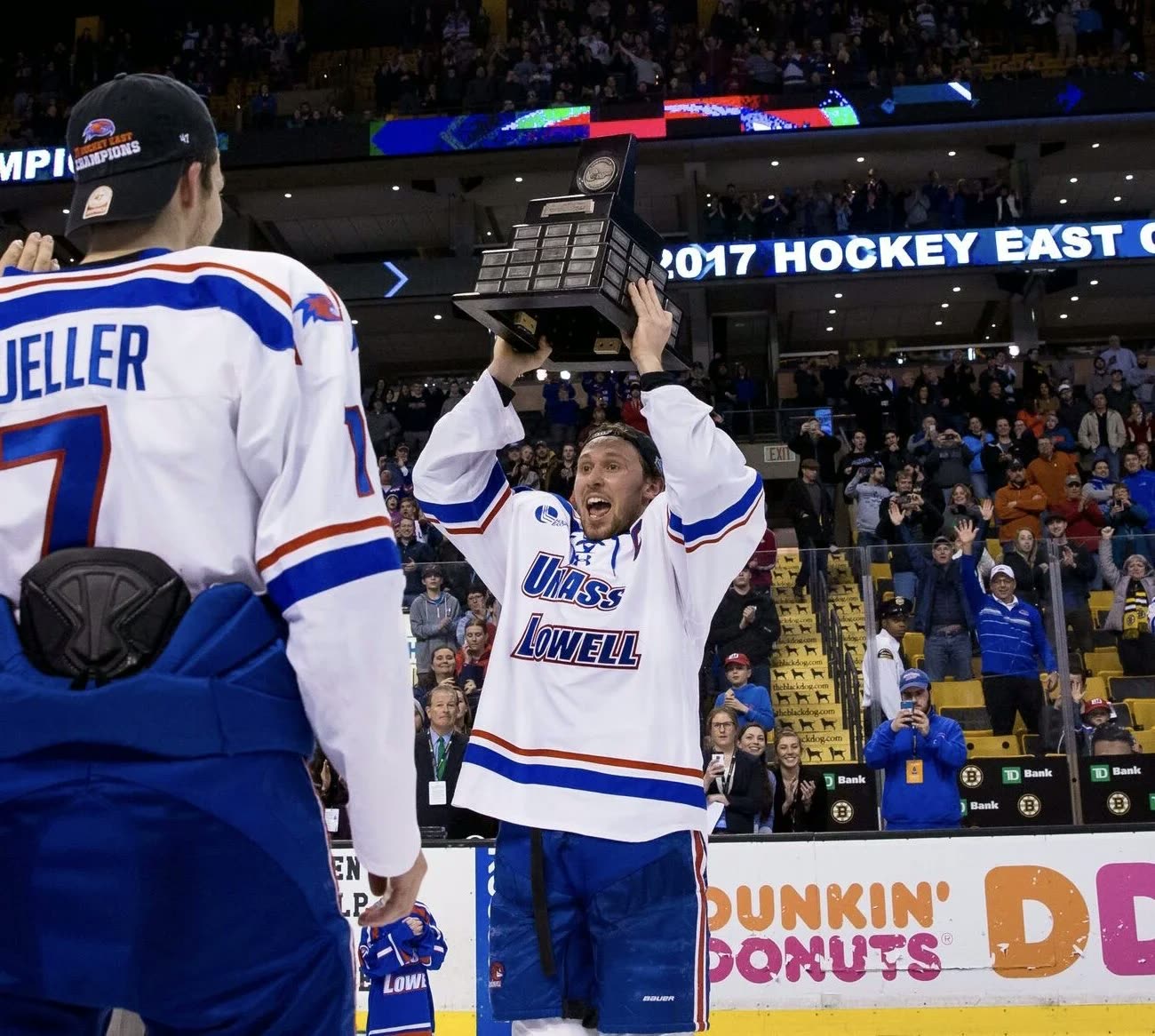 Michael Kapla raising the Hockey East trophy